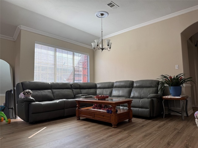 living room featuring a chandelier, ornamental molding, and hardwood / wood-style floors