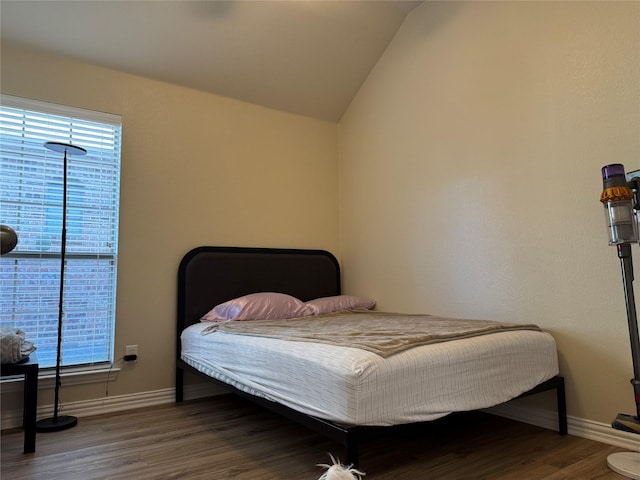 bedroom with vaulted ceiling and wood-type flooring