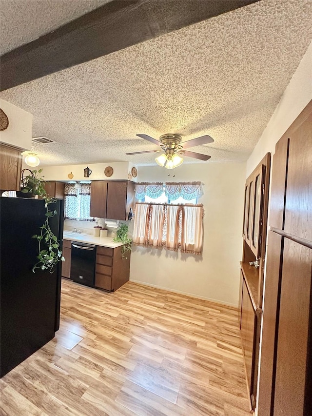 kitchen with black appliances, light wood-type flooring, and ceiling fan