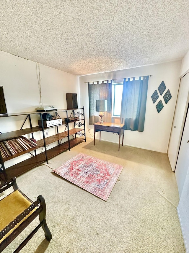 bedroom featuring carpet, a closet, and a textured ceiling