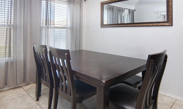 tiled dining room featuring a wealth of natural light and ornamental molding