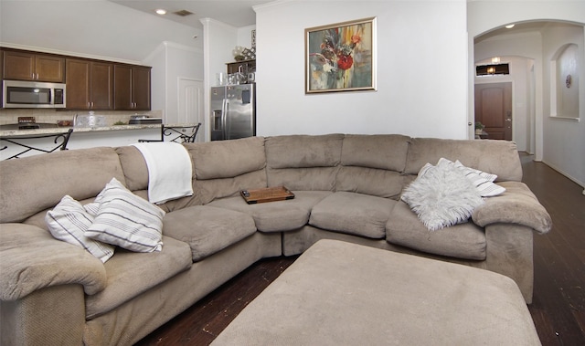 living room featuring dark hardwood / wood-style flooring and ornamental molding