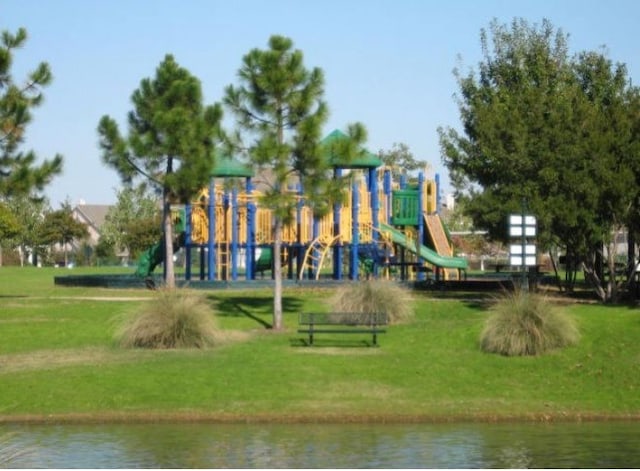 view of play area with a water view and a yard