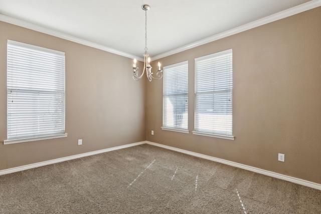 carpeted empty room with ornamental molding and a chandelier