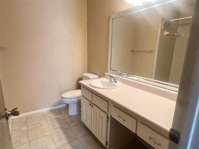 bathroom with toilet, walk in shower, and vanity