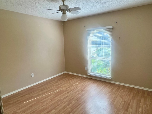 spare room with a textured ceiling, ceiling fan, and hardwood / wood-style floors