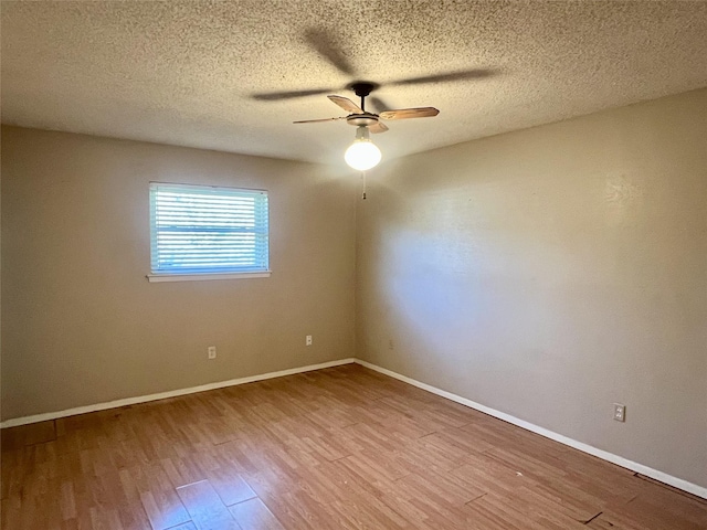 spare room with a textured ceiling, ceiling fan, and light hardwood / wood-style floors