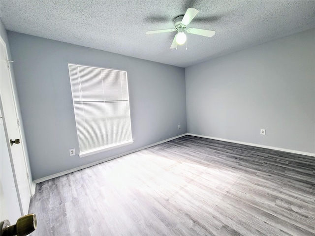 spare room featuring hardwood / wood-style floors, a textured ceiling, and ceiling fan