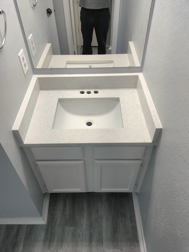 bathroom featuring hardwood / wood-style flooring and vanity