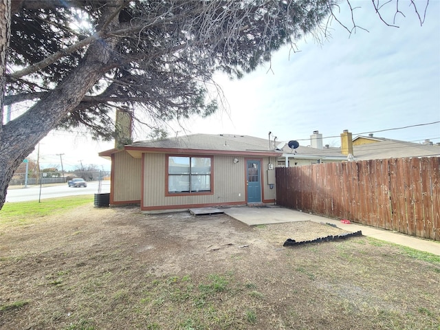 rear view of house with central AC and a patio