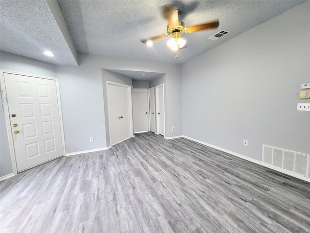 unfurnished bedroom featuring ceiling fan, light hardwood / wood-style flooring, and a textured ceiling