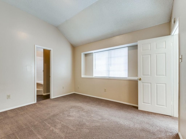 unfurnished bedroom with carpet and vaulted ceiling