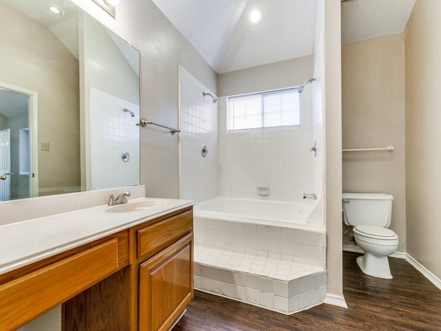 full bathroom featuring lofted ceiling, tiled shower / bath, vanity, toilet, and hardwood / wood-style flooring