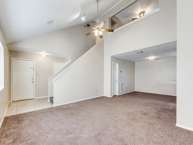 unfurnished living room featuring ceiling fan, light colored carpet, and high vaulted ceiling