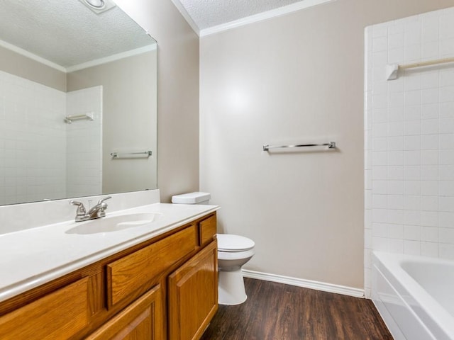 bathroom with toilet, hardwood / wood-style floors, a textured ceiling, ornamental molding, and vanity