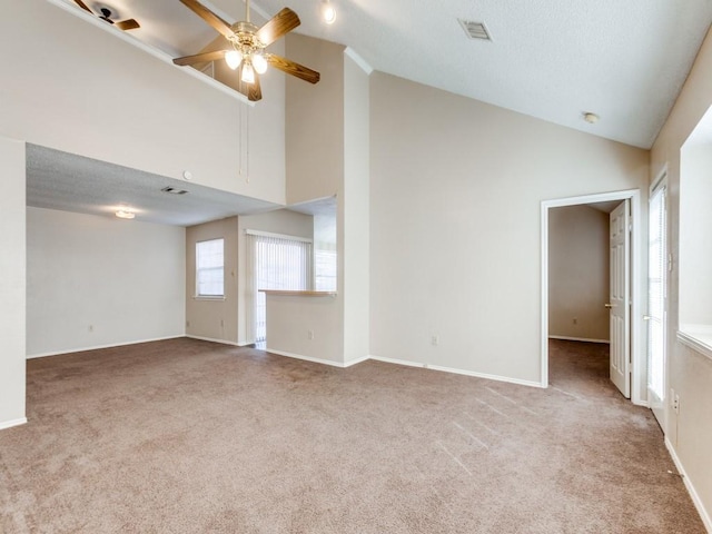 unfurnished living room with ceiling fan, carpet flooring, and high vaulted ceiling