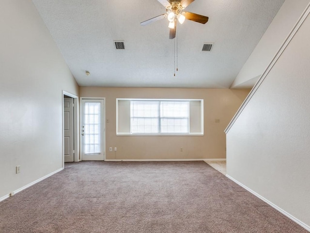 carpeted spare room with vaulted ceiling and ceiling fan