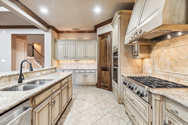 kitchen with custom exhaust hood, stainless steel appliances, tasteful backsplash, light stone counters, and sink