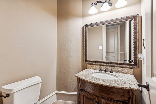 bathroom with toilet and vanity