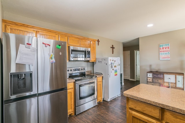 kitchen featuring dark wood-type flooring and stainless steel appliances