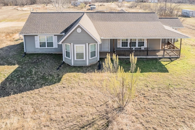 view of front of home with covered porch and a front yard