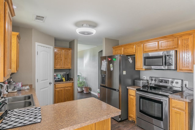 kitchen featuring dark hardwood / wood-style flooring, sink, and stainless steel appliances