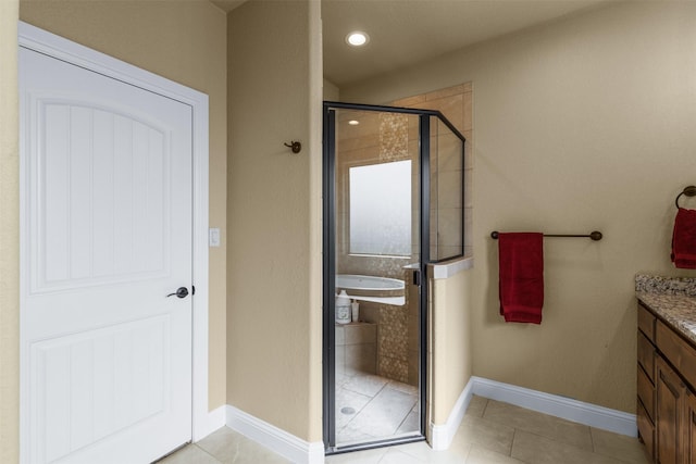 bathroom featuring vanity, tile patterned flooring, and walk in shower