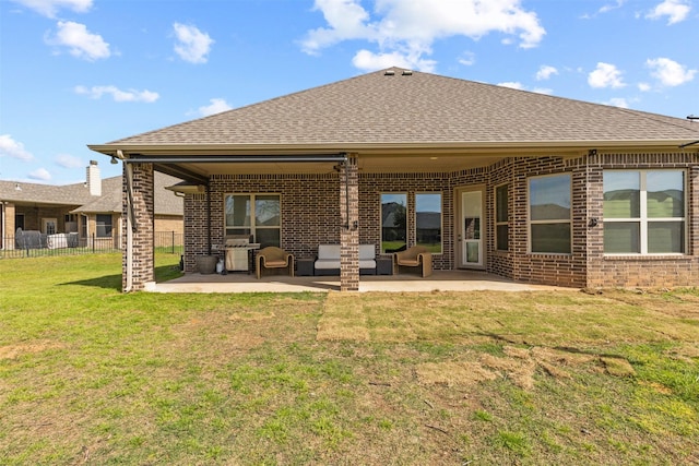 rear view of property featuring a lawn and a patio