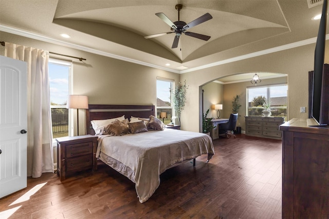 bedroom with ceiling fan, vaulted ceiling, dark wood-type flooring, and crown molding