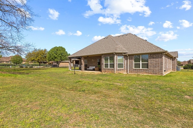 back of house featuring a yard and a patio