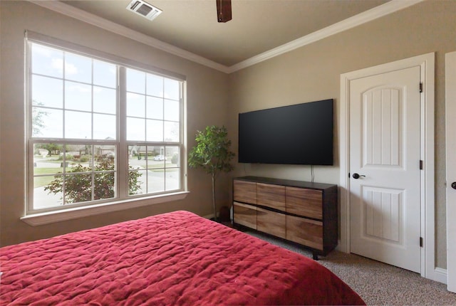 bedroom featuring ceiling fan, carpet flooring, ornamental molding, and multiple windows