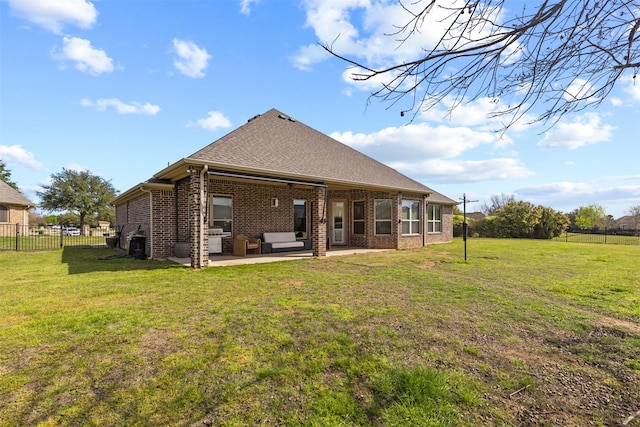 rear view of house featuring a yard and a patio