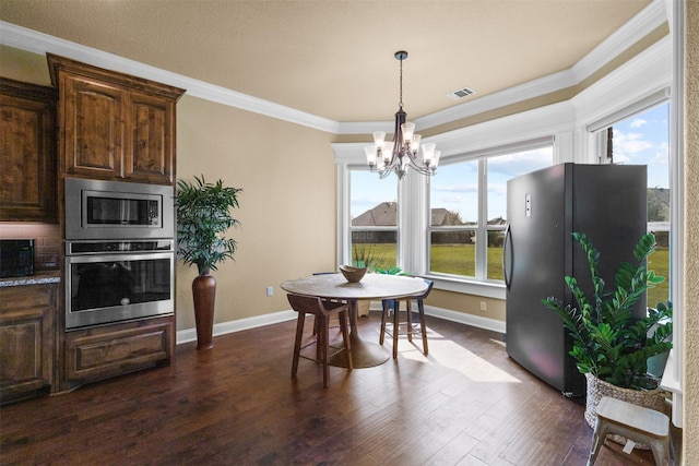 dining room with a chandelier, dark hardwood / wood-style flooring, and ornamental molding