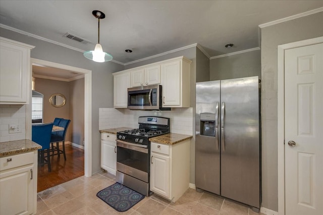 kitchen with light stone countertops, stainless steel appliances, white cabinets, and decorative light fixtures