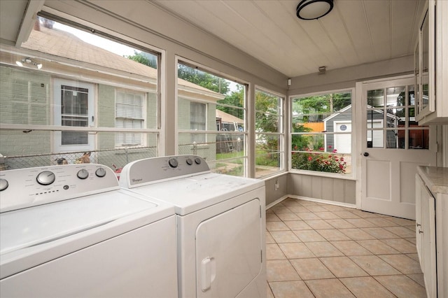 clothes washing area featuring independent washer and dryer and light tile patterned flooring