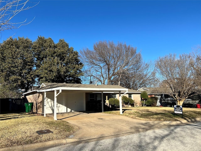 view of front facade with a front yard and a carport