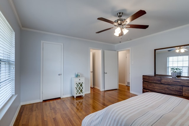 bedroom with light wood-type flooring, ceiling fan, and ornamental molding