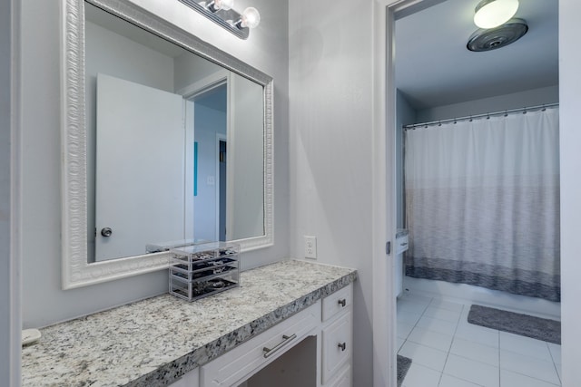 bathroom with shower / bath combo with shower curtain, tile patterned floors, and vanity