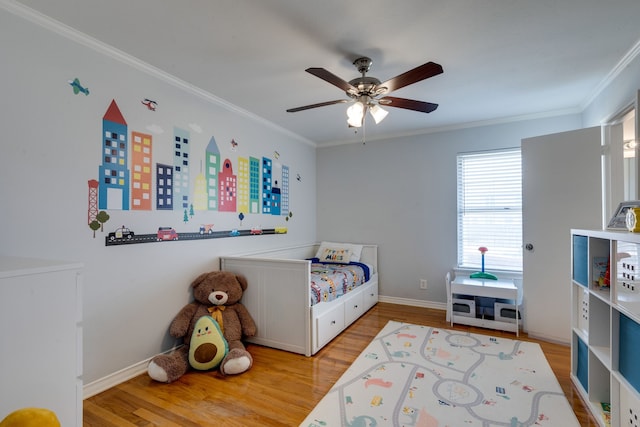 bedroom with crown molding, wood-type flooring, and ceiling fan