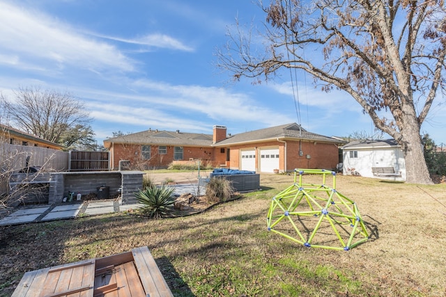 view of yard with a swimming pool, central air condition unit, a patio, and a garage