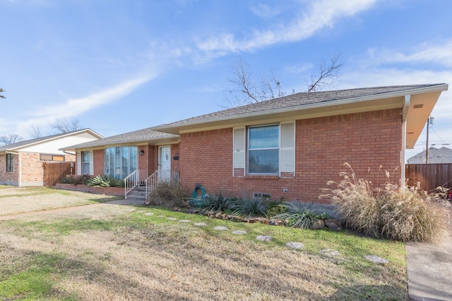 ranch-style home with a front lawn