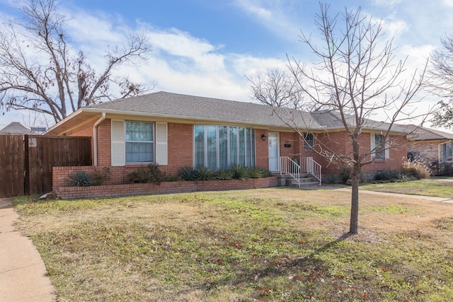 ranch-style home featuring a front yard