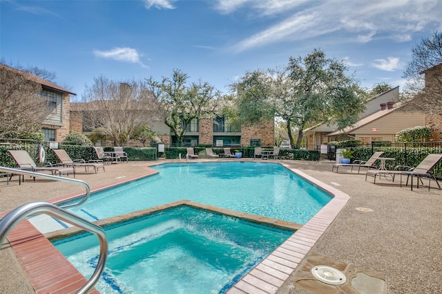 view of swimming pool with a patio area and a hot tub