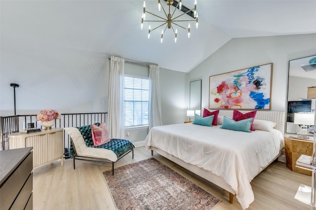 bedroom with lofted ceiling, light hardwood / wood-style floors, and a notable chandelier