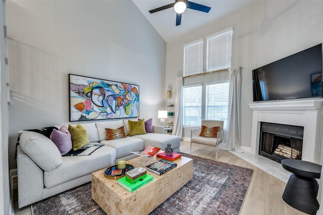 living room featuring high vaulted ceiling, ceiling fan, and hardwood / wood-style floors