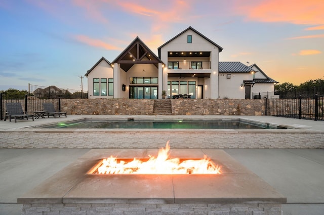 exterior space with an outdoor fire pit and a patio area