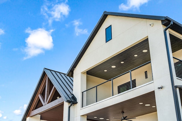 view of property exterior with ceiling fan and a balcony