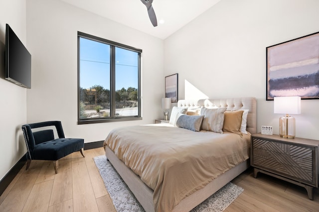 bedroom with lofted ceiling, light hardwood / wood-style flooring, and ceiling fan