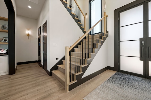 stairway with hardwood / wood-style flooring