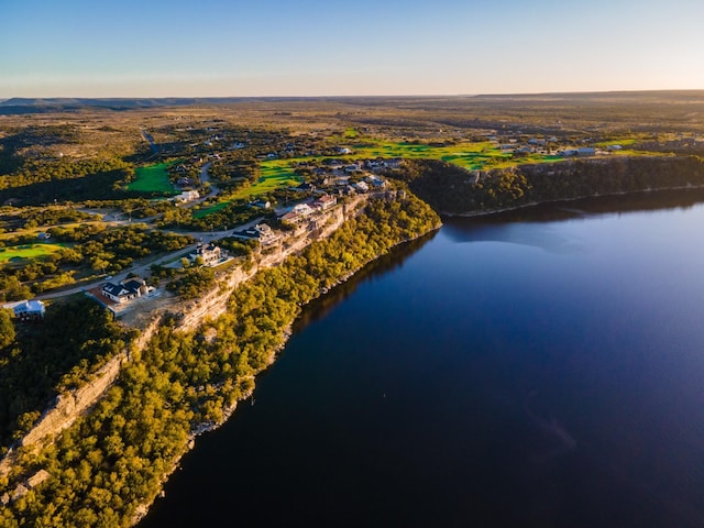 aerial view at dusk featuring a water view